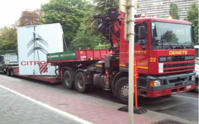 Crane trucks with low flatbed trucks for heavy duty transport.